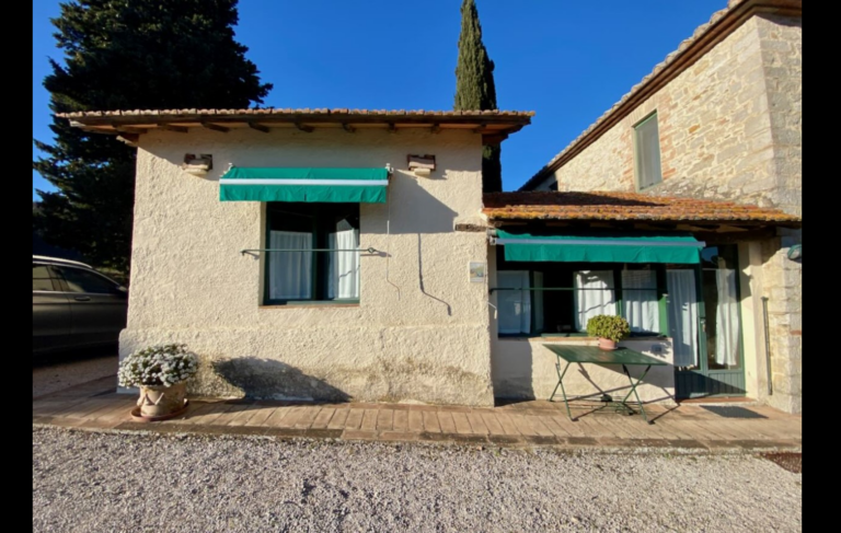Stone cottage with green awnings