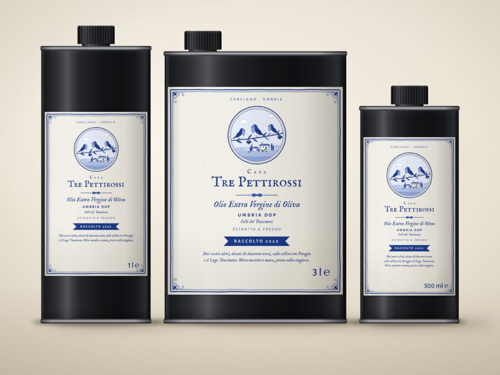 Three black tins of Casa Tre Pettirossi extra virgin olive oil with labels: 1 litre, 3 litres and 500 ml