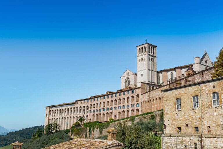 The Basilica of San Francesco in Assisi under a blue sky
