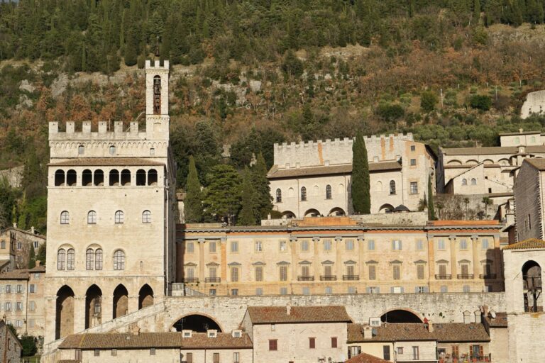 Medieval buildings of Gubbio against the green hills