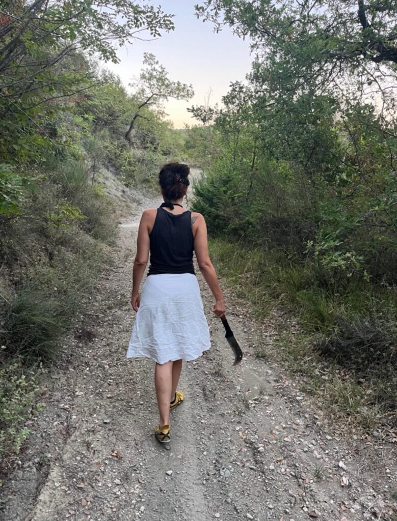 Walking a forest path on the estate with a machete