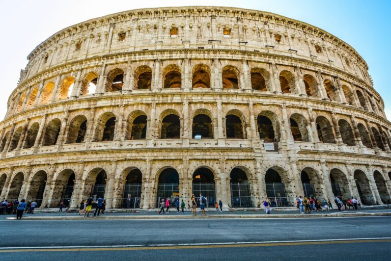 The Colosseum in Rome under a blue sky