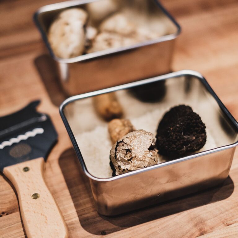 Truffles in metal boxes on a wooden counter